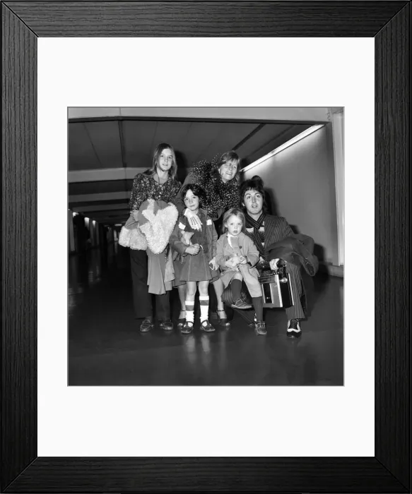 Framed Print : Pop star Paul McCartney and family. Carrying a portable radio