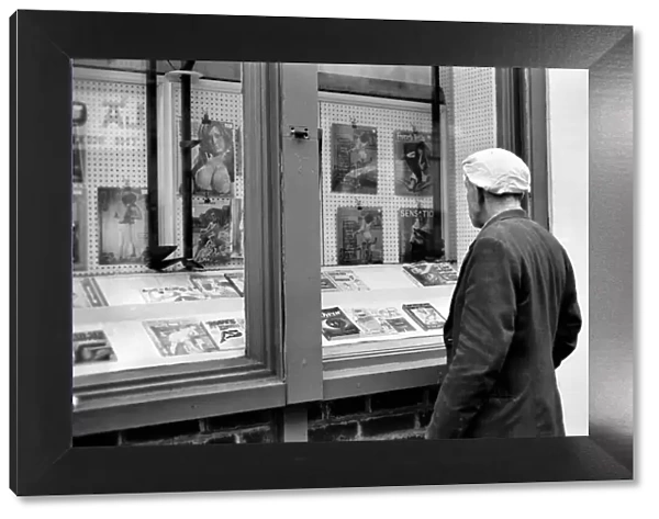 Man loooking in a book shop window in Soho. December 1970 70-11636-004
