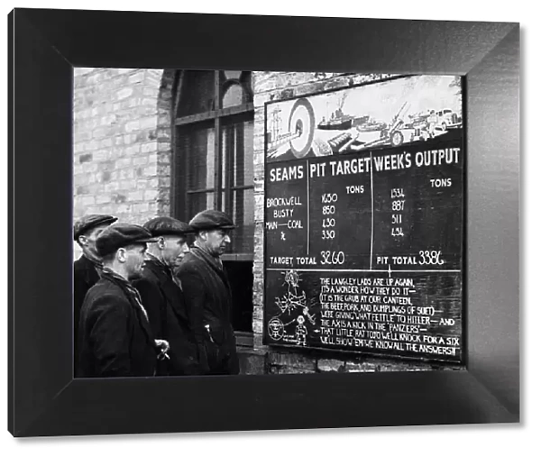 Miners at Langley Park Colliery on their way to work stop for a glance at their record