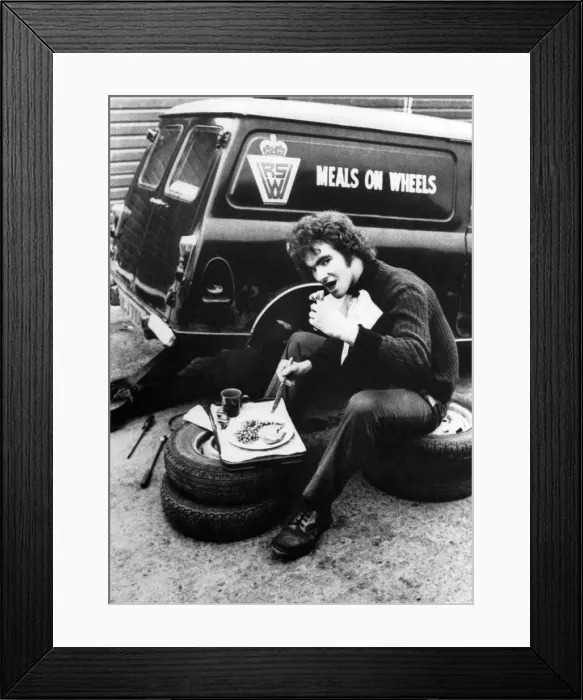 Framed Print : Driver makes the most of the food and has a spot of lunch while the meals on wheels van Framed Print : Driver makes the most of the food and has a spot of lunch while the meals on wheels van