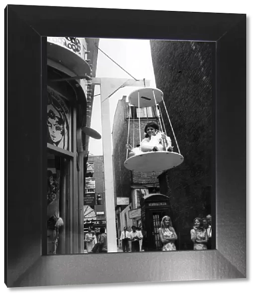 Sylvia Bryan in her birdcage outside the boutique. July 1967 P006383