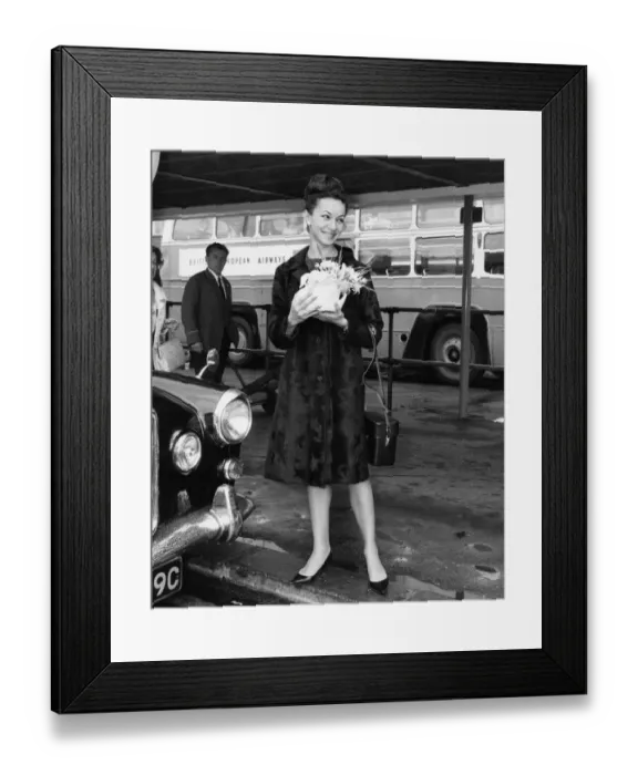 Framed Print : Magdalena Popa holding flowers waiting for a lift. June 1966 P005931 Framed Print : Magdalena Popa holding flowers waiting for a lift. June 1966 P005931
