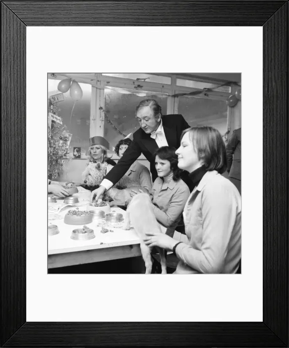 Framed Print : Dog Owners and their pets seen here having a Christmas party as actor Ronald Fraser acts Framed Print : Dog Owners and their pets seen here having a Christmas party as actor Ronald Fraser acts