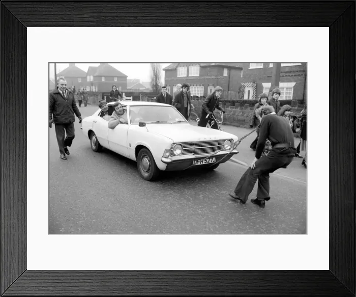 Framed Print : Strongman Reg Morris pulls car and passengers with his teeth. February 1975 75-00777-002 Framed Print : Strongman Reg Morris pulls car and passengers with his teeth. February 1975 75-00777-002
