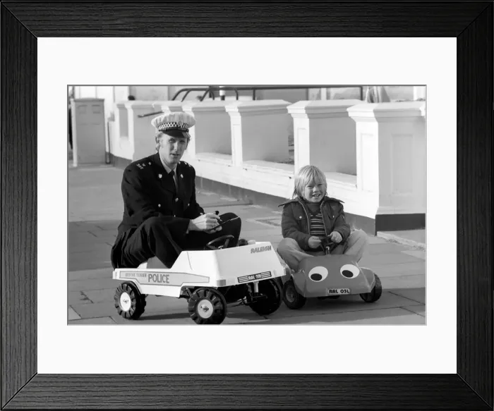 Framed Print : 1975 Brighton Toy Fair. Police cut backs mean this traffic cop can only pull over Framed Print : 1975 Brighton Toy Fair. Police cut backs mean this traffic cop can only pull over