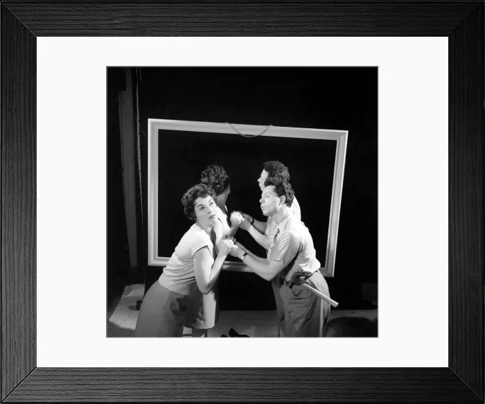 Framed Print : Mirror image: A couple argue in front of a mirror. 1958 Framed Print : Mirror image: A couple argue in front of a mirror. 1958