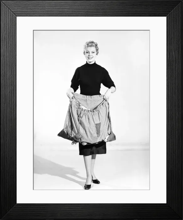 Framed Print : Woman wearing Dutch apron that converts into a bag. 1955 Framed Print : Woman wearing Dutch apron that converts into a bag. 1955