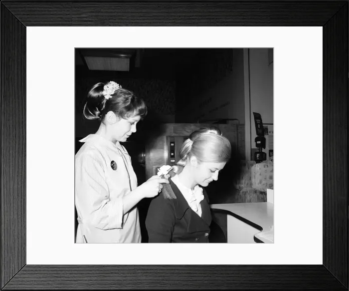 Framed Print : Woman at the beauty department of Selfridges store having a Tovar- tress attached to her