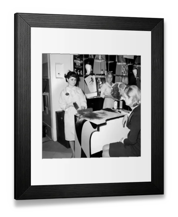 Framed Print : Woman at the beauty department of Selfridges store having a Tovar- tress attached to her