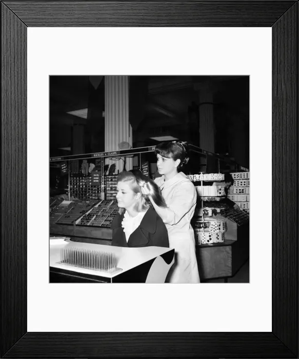Framed Print : Woman at the beauty department of Selfridges store having a Tovar- tress attached to her