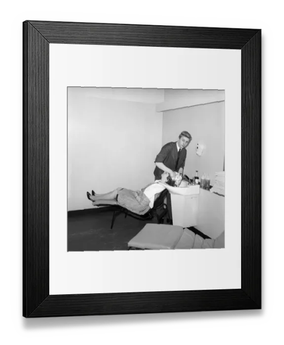 Framed Print : Woman having her hair washed at the John London Hair and Beauty Saloon. 1960