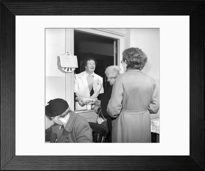 Framed Print : Women chat, share a cup of tea and read the newspapers at a womens lodging house