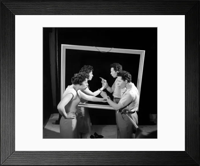 Framed Print : Mirror image: A couple argue in front of a mirror. 1958 Framed Print : Mirror image: A couple argue in front of a mirror. 1958