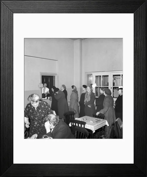 Framed Print : Women chat, share a cup of tea and read the newspapers at a womens lodging house