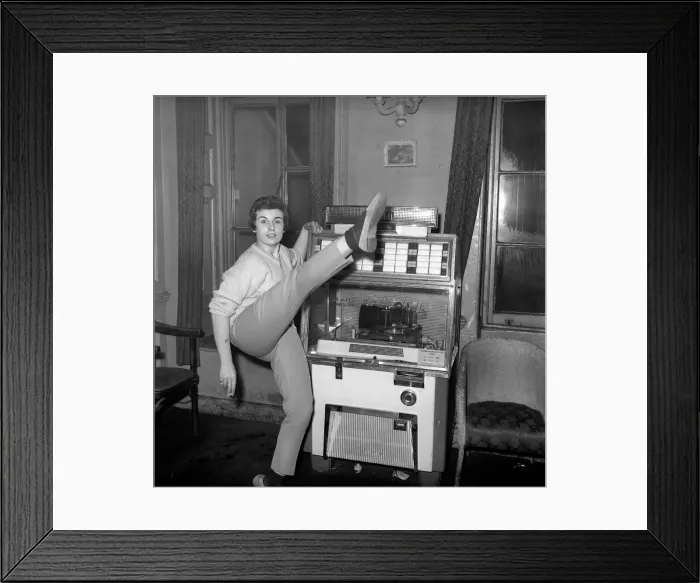 Framed Print : Woman selected tracks from juke box. 1960