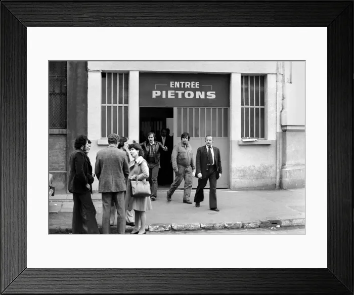 Framed Print : Renault factory workers leaving at the end of a shift through a door marked Framed Print : Renault factory workers leaving at the end of a shift through a door marked