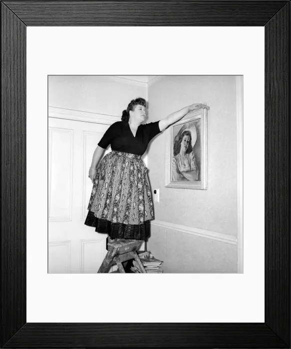Framed Print : Domestic Life: Woman (Mrs. Olive Haugh) dusting the picture frame. Circa 1954