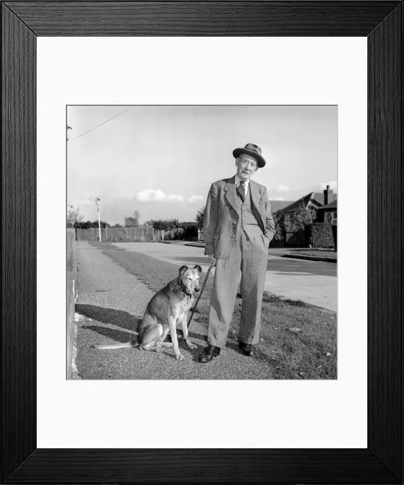 Framed Print : Mans best friend: Man walking a dog. Circa 1954 Framed Print : Mans best friend: Man walking a dog. Circa 1954