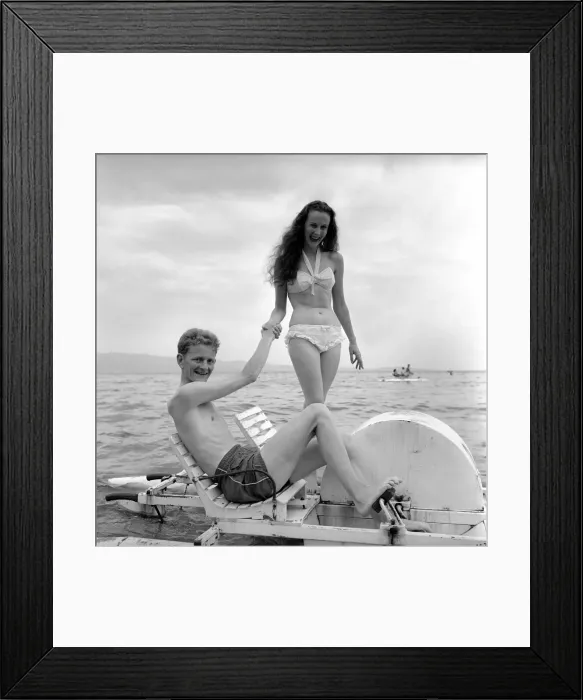 Framed Print : Holidays: Couple riding on a pedalo off the coast of Corsica. August 1957 Framed Print : Holidays: Couple riding on a pedalo off the coast of Corsica. August 1957