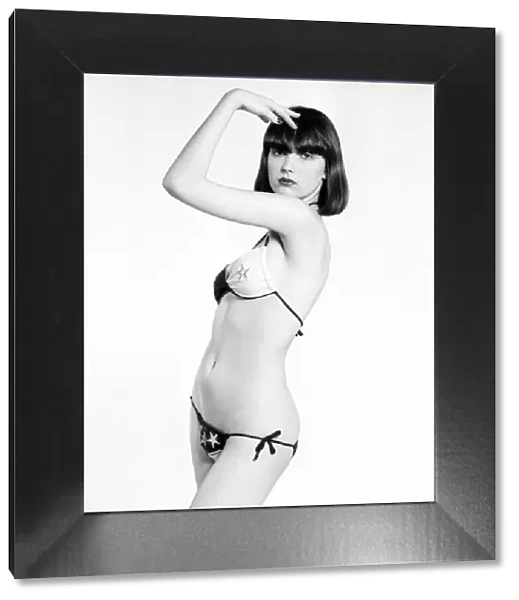 Model Marianne poses wearing a bikini in the studio. April 1975