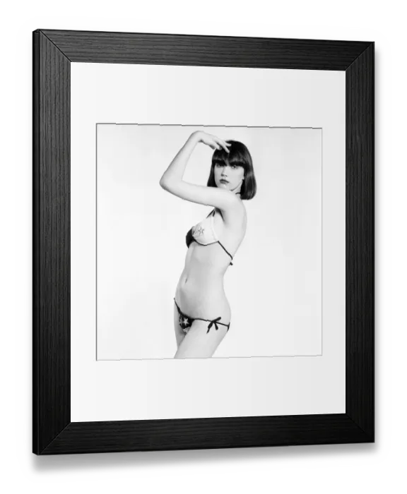 Framed Print : Model Marianne poses wearing a bikini in the studio. April 1975