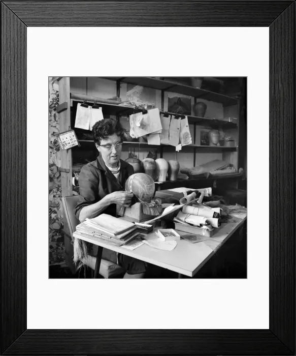 Framed Print : Wigmakers Workshop: Women making wigs whilst in another part of the workshop hair is