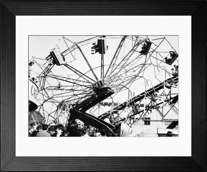 Framed Print : The Spanish City amusement park in Whitley Bay - holidaymakers enjoy a spin on one of Framed Print : The Spanish City amusement park in Whitley Bay - holidaymakers enjoy a spin on one of