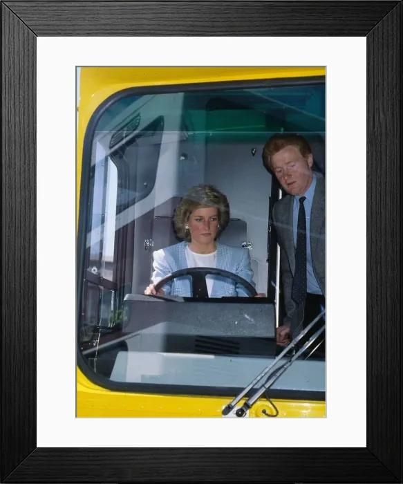 Framed Print : Princess Diana, Princess of Wales at the wheel of a bus watched by John Fowler during a