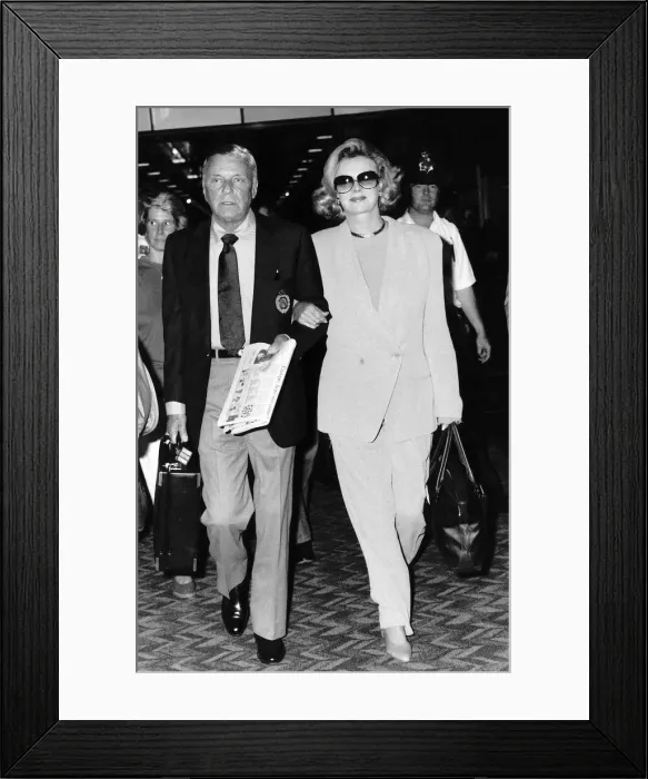 Framed Print : Frank Sinatra Walking with a woman holding a case and a newspaper