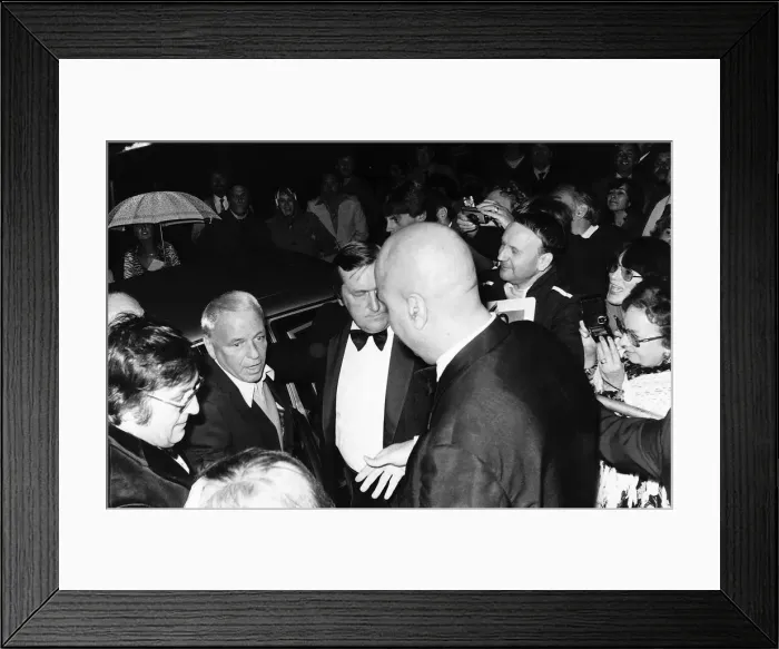 Framed Print : Frank Sinatra Singer and Actor flanked by bodyguards as he arrived at the Albert Hall