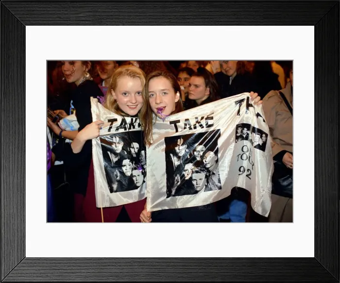 Framed Print : Girl fans of pop group take That holding a flag with the group Framed Print : Girl fans of pop group take That holding a flag with the group