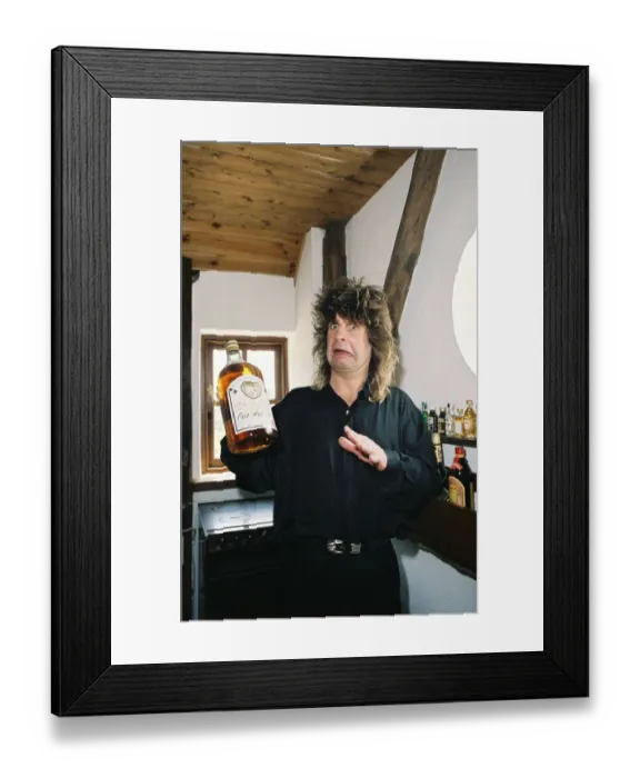 Framed Print : Ozzy Osbourne rock singer with the group Black Sabbath, holding a bottle of whiskey