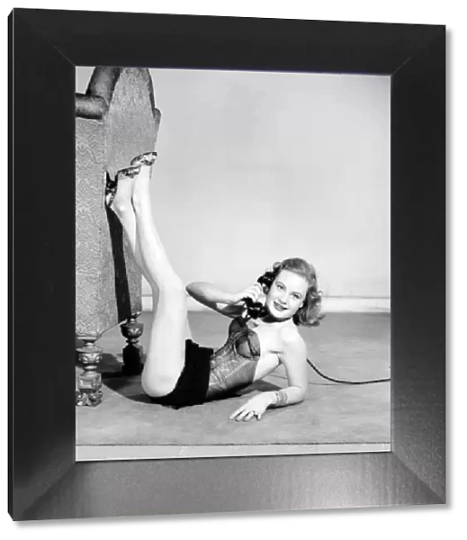 Model wearing underwear on telephone. July 1956 E227-004