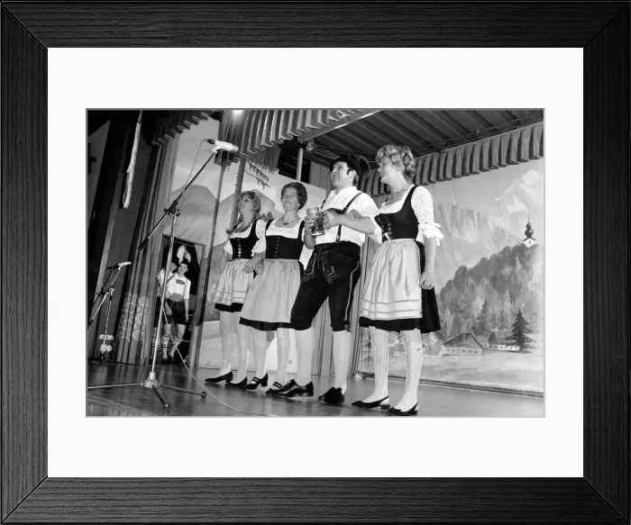 Framed Print : Members of a Bavarian band performing on stage wearing traditional Bavarian dress during