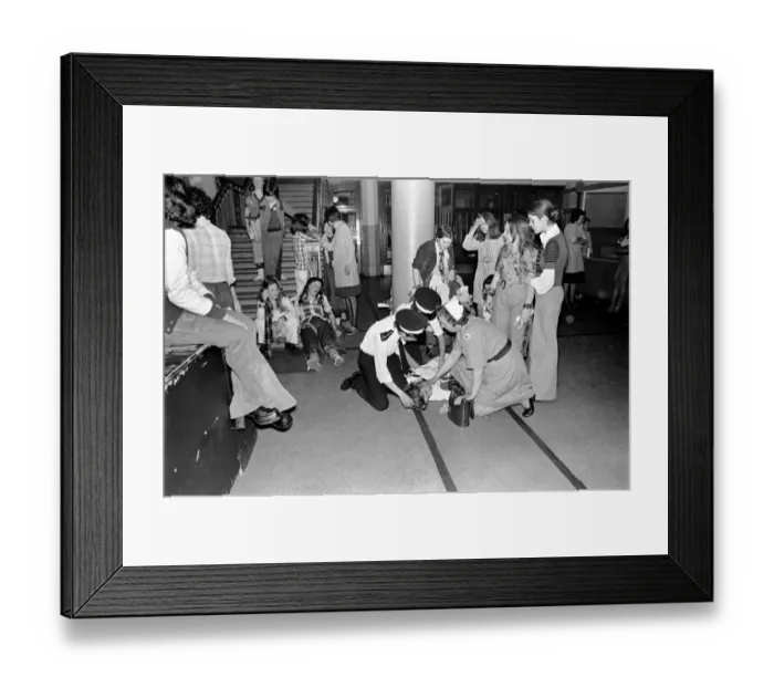 Framed Print : Medical officers attend to injured fans of the Bay City Rollers at their gig in Cardiff