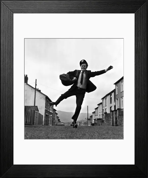 Framed Print : Fred Henderson, 49, makes speedy deliveries with the local post with balletic leaps along