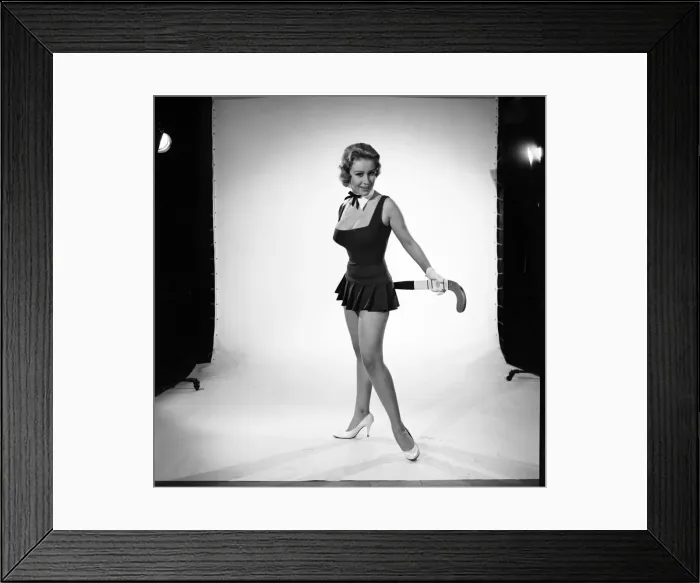Framed Print : Rita Royce modelling sports kit with hockey stick. Circa 1959 Framed Print : Rita Royce modelling sports kit with hockey stick. Circa 1959