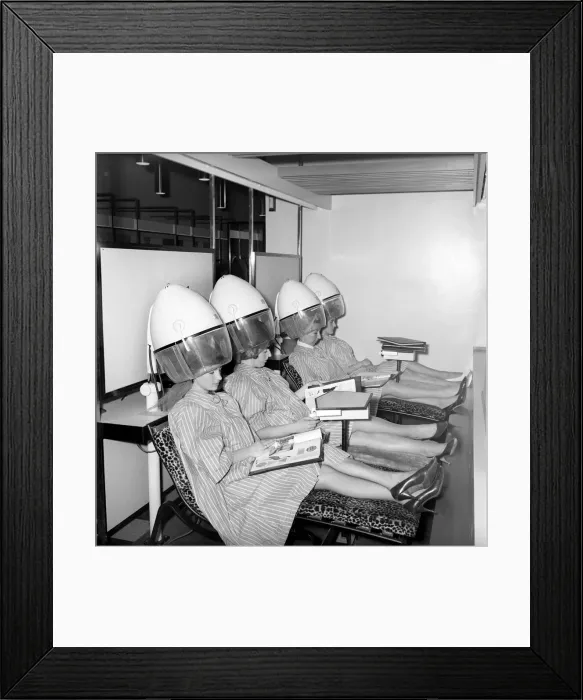 Framed Print : Women reading magazines at the John London Hair and Beauty Saloon whilst under the driers Framed Print : Women reading magazines at the John London Hair and Beauty Saloon whilst under the driers
