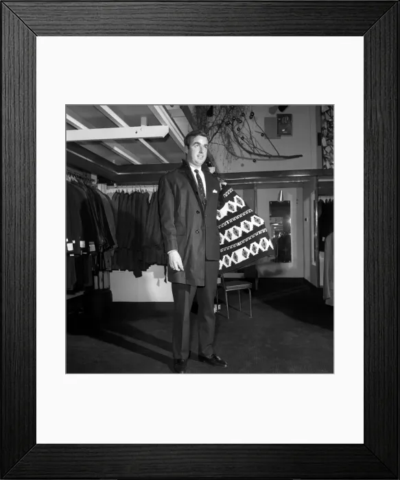 Framed Print : Male model wearing raincoat in menswear department. 1966
