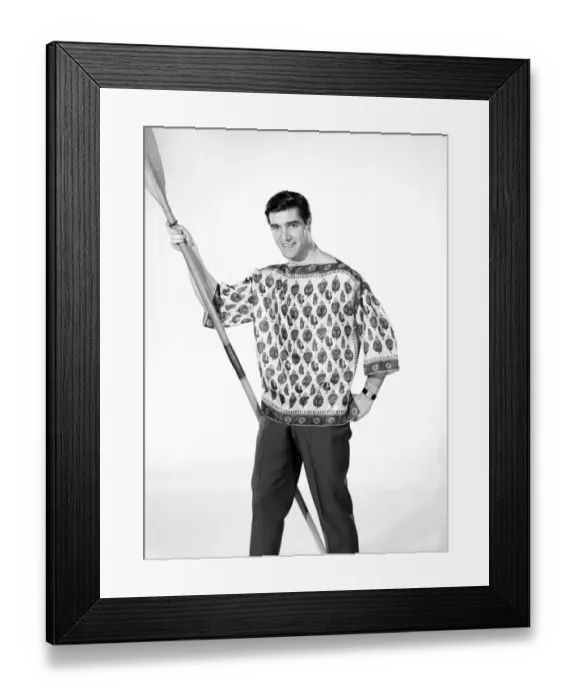 Framed Print : Male model Peter Christian wearing silk shirt seen here holding a oar. Circa 1964