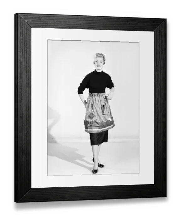 Framed Print : Woman wearing Dutch apron that converts into a bag. 1955 Framed Print : Woman wearing Dutch apron that converts into a bag. 1955