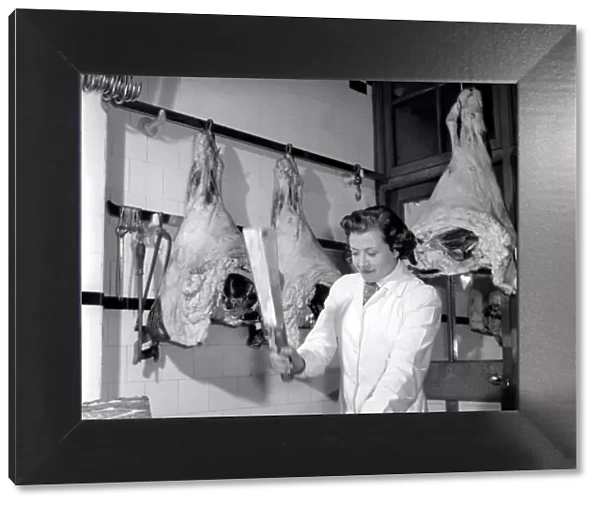 Woman butcher seen here at work. 1954