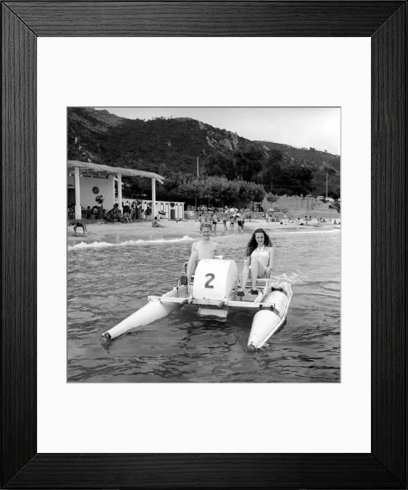 Framed Print : Holidays: Couple riding on a pedalo off the coast of Corsica. August 1957