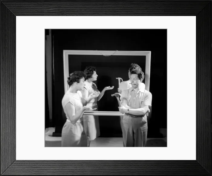 Framed Print : Mirror image: A couple argue in front of a mirror. 1958
