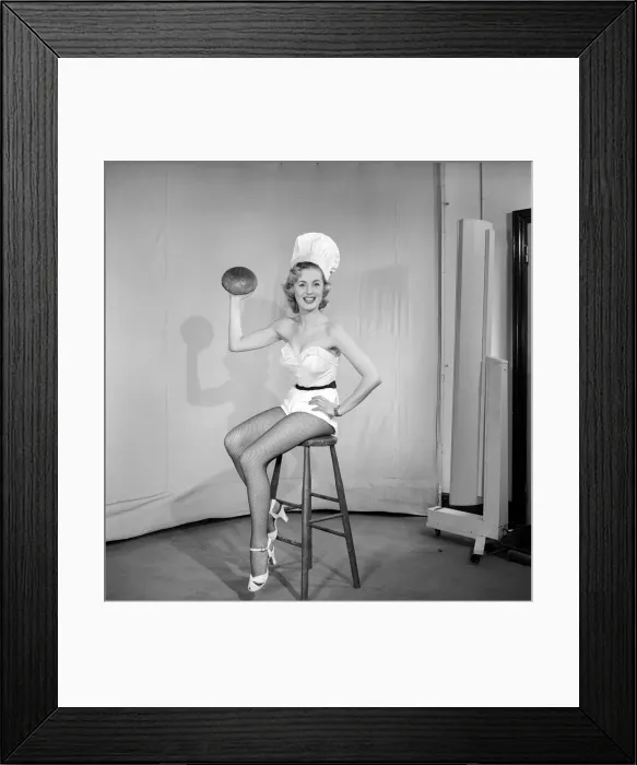 Framed Print : Woman wearing chefs hat holding loaf of bread. 1959 E61-002