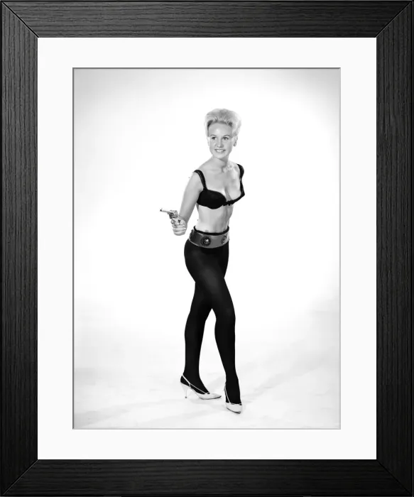 Framed Print : Model Brenda Bartlet dressed as Bond girl holding gun. October 1959 Framed Print : Model Brenda Bartlet dressed as Bond girl holding gun. October 1959