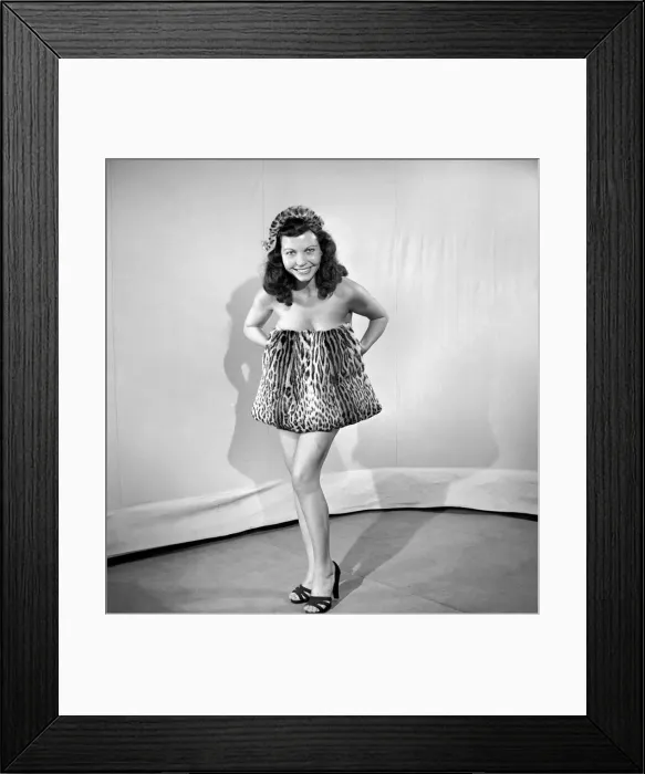 Framed Print : Model wearing leopard skin mini dress and matching muff. 1964 Framed Print : Model wearing leopard skin mini dress and matching muff. 1964