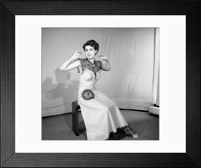 Framed Print : Woman modelling the latest evening dress fashions in the Reveille studios Framed Print : Woman modelling the latest evening dress fashions in the Reveille studios