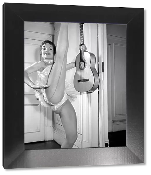 Show dancer Margot Pritchard seen here performing with a guitar. 1958