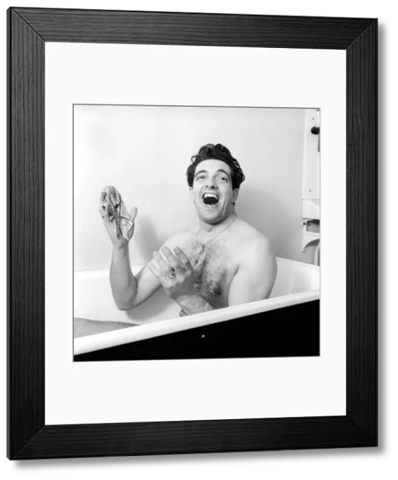 Framed Print : Singer Frankie Vaughan seen here singing in the bath at the family home. Circa 1957